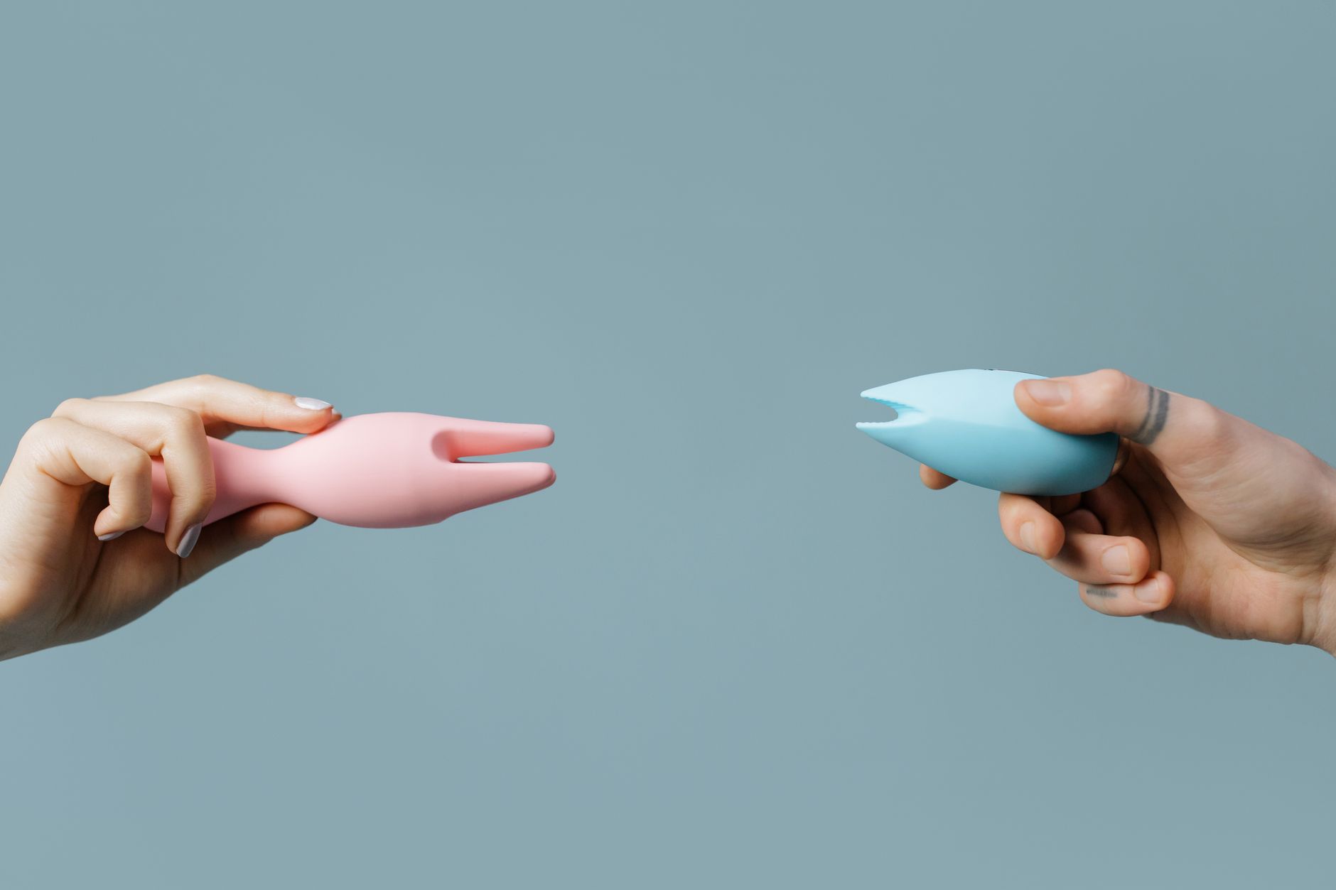Close-up of hands holding a sleek vibrator, symbolizing intimate reconnection and sensory awakening