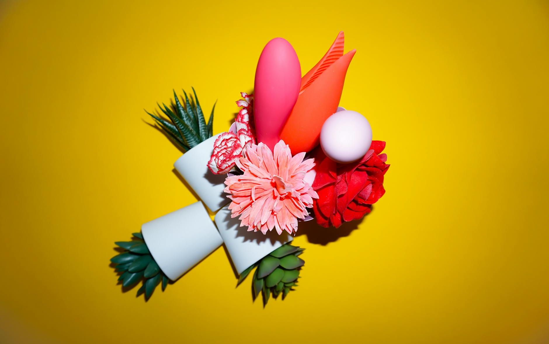 Bright, minimalist arrangement of lemon slices and abstract objects on yellow background