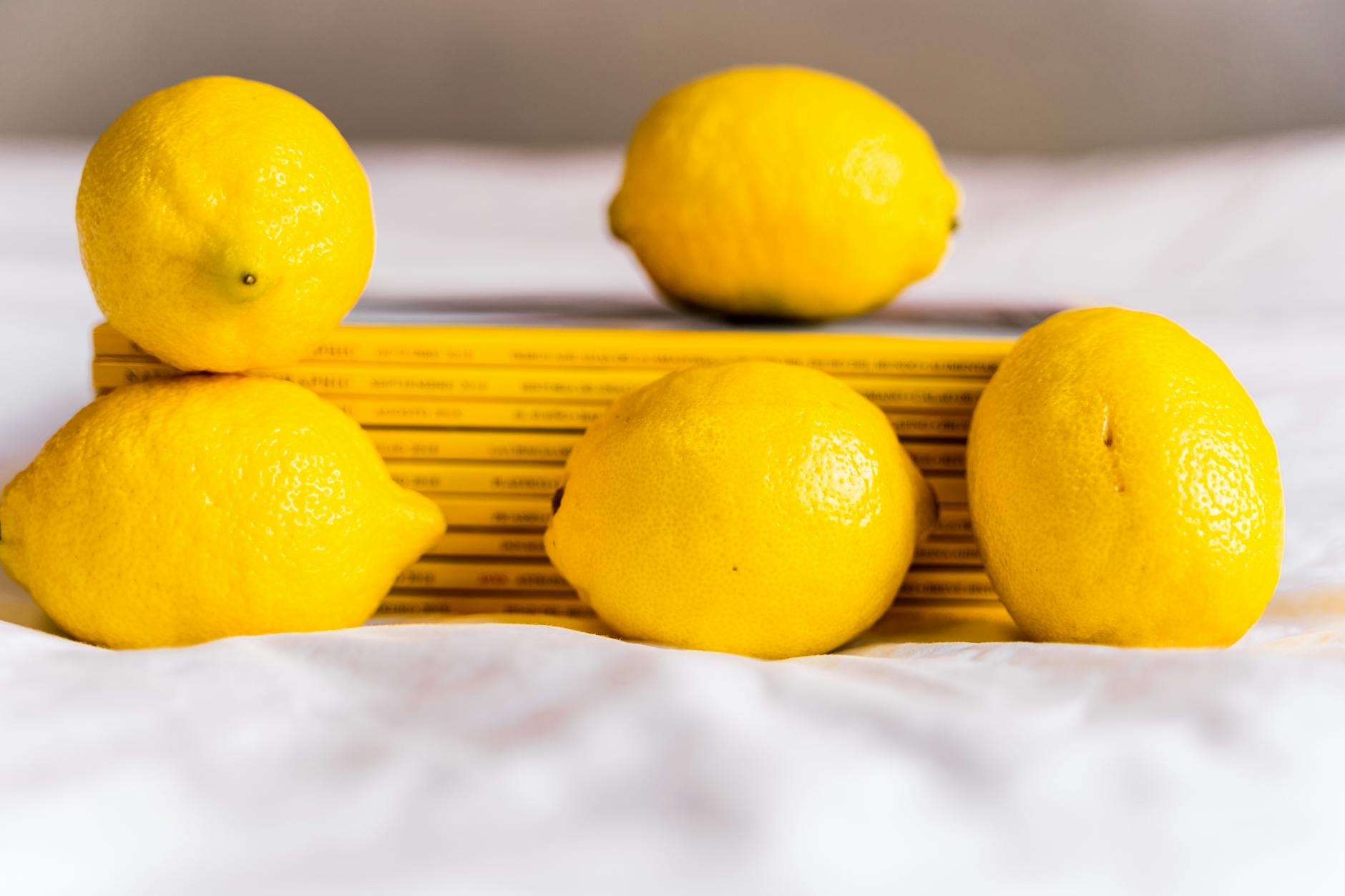 Fresh yellow lemons stacked with books, symbolizing new chapters and fresh starts
